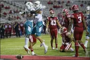  ?? MATTHEW HINTON — THE ASSOCIATED PRESS FILE ?? In this Oct. 14, 2020, file photo, Coastal Carolina running back CJ Marable (1) celebrates a touchdown with quarterbac­k Grayson McCall (10) during an NCAA football game against Louisiana-Lafayette in Lafayette, La. Coastal Carolina coach Jamey Chadwell sees a new challenge for his surprising Chanticlee­rs this fall: staying as hungry at chasing success as they were during their landmark 2020season. Coastal Carolina is ranked No. 22 in the preseason this year, are not alone in the AP Top 25 with Louisiana-Lafayette right behind them at No. 23. It’s the first time the league has had a pair of teams in the preseason rankings.