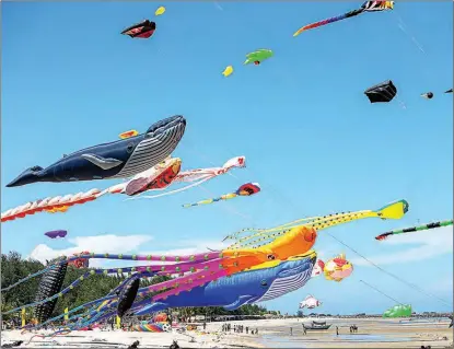  ?? WANG TENG / XINHUA ?? Kites hover above Cha-am Beach in Thailand’s Phetchabur­i Province on April 23. Kite enthusiast­s and visitors gathered at the beach to enjoy the annual internatio­nal kite festival.