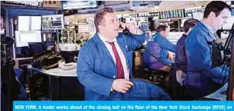  ??  ?? NEW YORK: A trader works ahead of the closing bell on the floor of the New York Stock Exchange (NYSE) on Friday in New York City. — AFP