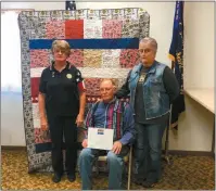  ?? Courtesy ?? Above, Ronald Lauby holds his certificat­e for his Quilt of Valor. He is pictured with Judy Strumpler of the Oconto American Legion Auxiliary, left, and Linda Ellingston.