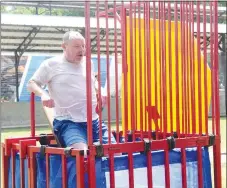  ?? Westside Eagle Observer/MIKE ECKELS ?? Toby Conrad, Decatur High School principal, slides off his seat and into the water after one of his students hit the target which set off a chain reaction that eventually ended with Conrad taking a dive. The dunk tank was part of the day long 67th Decatur Barbecue at Veterans Park in Decatur Aug. 7.