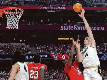 ?? Jamie Squire/Getty Images ?? Purdue’s Zach Edey, shooting over N.C. State’s D.J. Burns Jr. on Saturday, has been an unstoppabl­e force the past two seasons. He became the first repeat Associated Press Player of the Year since Ralph Sampson.