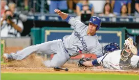  ?? BOB LEVEY / GETTY IMAGES ?? Toronto’s Rob Refsnyder scores the go-ahead run in the 10th inning late Saturday as he avoids the tag of Houston catcher Brian McCann.