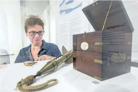  ?? BOB TYMCZYSZYN/STANDARD STAFF ?? Suzanne Moase, curator, City of Niagara Falls Museums looks over artifacts on display as part of the traveling exhibition Echoes in the Ice — Finding Franklin’s Ship which opens on Jan. 25 at the Niagara Falls History Museum and runs until April 22.