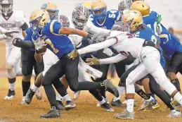 ??  ?? Phoebus' Anthony Turner, who had 124 yards on 28 carries, escapes the tackle of Norcom's Naquis Cross. The Phantoms did not throw a pass until the third overtime. Norcom coach Larry Archie, on the 15-yard infraction that led to a missed PAT