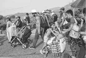  ??  ?? The caravan includes many children making the journey on foot to the U.S. border, which is expected to take at least a month longer.