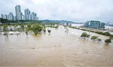  ?? Korea Times photo by Lee Han-ho ?? A park near Banpo Bridge, located on the southern side of Han River in Seoul, is submerged, Monday, due to torrential rains that have been pounding the country’s interior regions since the weekend.