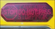  ?? RICARDO B. BRAZZIELL / AMERICAN-STATESMAN ?? The district’s buses offer bus safety reminders for Austin drivers. Passing a stopped school bus illegally can result in a $300 ticket being mailed to the vehicle owner by an Arizona firm that keeps 60 percent of the revenue.