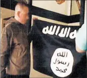  ?? FBI 2017 ?? A video image shows Sgt. 1st Class Ikaika Kang with an ISIS flag after allegedly pledging allegiance to the group.