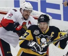  ?? GENE J. PUSKAR/THE ASSOCIATED PRESS ?? Senators defenceman Dion Phaneuf clears Sidney Crosby of the Penguins from the Ottawa crease in Saturday night’s Eastern final opener.