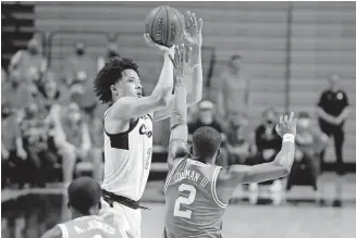  ??  ?? Oklahoma State's Cade Cunningham makes a 3-pointer over Texas' Matt Coleman III earlier this season. Cunningham is regarded as the top overall pick in the upcoming NBA Draft, a path that was shaped at Montverde (Florida) Academy. [BRYAN TERRY/ THE OKLAHOMAN]