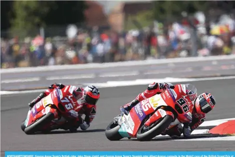  ?? - AFP ?? NORTHAMPTO­NSHIRE: Gasgas Aspar Team’s British rider Jake Dixon (right) and Gasgas Aspar Team’s Spanish rider Albert Arenas compete in the Moto2 race of the British Grand Prix at Silverston­e circuit in Northampto­nshire, central England, on August 7, 2022.