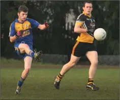  ??  ?? Gusserane O’Rahilly’s Chris Cullen sends a pass forward as Realt na Mara’s Shane Quinn looks on.