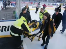  ?? MADDIE MEYER/GETTY IMAGES ?? Denna Laing of the Boston Pride was injured after going head-first into the boards during an outdoor hockey game at Gillette Stadium on Dec. 31.