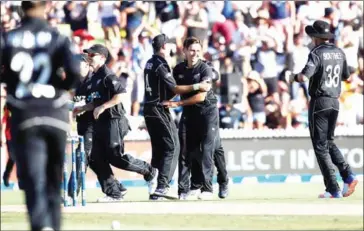  ?? MICHAEL BRADLEY/AFP ?? Trent Boult (centre) of New Zealand celebrates his six-wicket haul in the one-day internatio­nal match against Australia at Seddon Park in Hamilton yesterday.