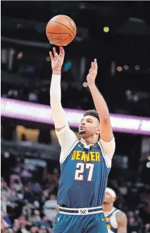  ?? JACK DEMPSEY THE ASSOCIATED PRESS ?? Denver Nuggets guard Jamal Murray, of Kitchener, rolled his left ankle late in the first half of a game Wednesday against Charlotte.