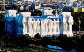  ??  ?? The sunset illuminate­s the German reichstag wrapped with silver polypropyl­ene fabric, during the ‘Wrapped reichstag’ project by conceptual artists Christo and Jeanne Claude in Berlin, Germany in 1995. — reuters