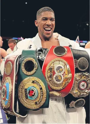  ?? Picture: Getty Images. ?? Anthony Joshua with his WBO, WBA and IBF heavyweigh­t his unanimous points victory over Joseph Parker. belts following