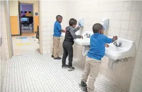  ?? JAY JANNER/USA TODAY NETWORK ?? Boys wash their hands at a charter school in Austin, Texas, on April 1.