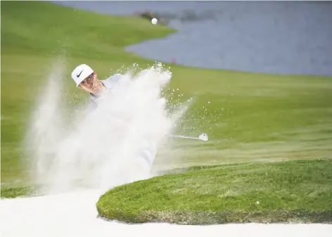  ?? Ross Kinnaird / Getty Images ?? Thorbjorn Olesen hits from the bunker on the 16th hole on his way to a share of the lead with a 67 during the PGA Championsh­ip.