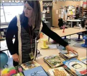  ?? JERRY DAVICH/POST-TRIBUNE ?? Tina DeBrock, a kindergart­en teacher at Protsman Elementary School in Dyer, Ind., looks through some of the donated books on mental health wellness.