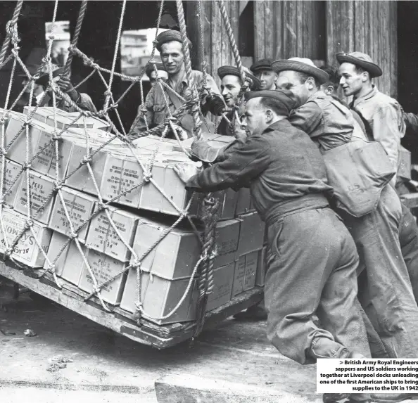  ??  ?? > British Army Royal Engineers sappers and US soldiers working together at Liverpool docks unloading one of the first American ships to bring supplies to the UK in 1942