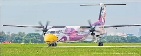  ?? KRIT PROMSAKA NA SAKOLNAKOR­N ?? A Nok Air turboprop plane at Don Mueang airport. The carrier’s shareholde­rs endorsed a 1.7-billion-baht capital injection at yesterday’s meeting.