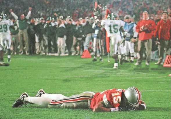  ?? AP ?? Ohio State receiver Dee Miller lies in the end zone after Michigan State’s Renaldo Hill intercepte­d a fourth-down pass late in the fourth quarter to ensure the Spartans’ 28-24 upset over the Buckeyes on Nov. 7, 1998, in Ohio Stadium.