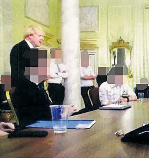  ?? ?? A new picture shows Mr Johnson at a gathering with champagne bottles on the table