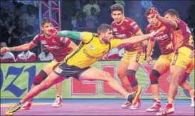  ?? PKL ?? Telugu Titans’ Rahul Chaudhari (centre) tries to touch one of the UP Yoddha defenders on Thursaday.
