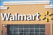  ?? Getty Images ?? Walmart announced it would raise the minimum wage for more than a million U.S. workers to $11 an hour and pay bonuses.