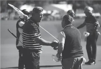  ?? ROSS KINNAIRD/GETTY IMAGES ?? Hal Sutton of the United States shakes hands with Ian Woosnam of Europe during the 2016 Ryder Cup captains matches at Hazeltine National Golf Club on Thursday in Chaska, Minn.