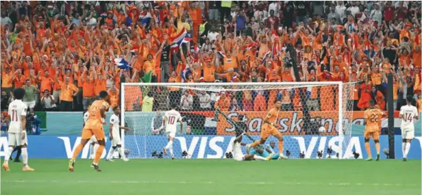  ?? (AFP) ?? Netherland­s’ forward Cody Gakpo (centre) celebrates scoring the opening goal during the FIFA World Cup Qatar 2022 Group A match against hosts Qatar at the Al Bayt Stadium on Tuesday.