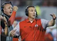  ?? SUE OGROCKI — ASSOCIATED PRESS ?? Urban Meyer, right, and then-assistant coach Zach Smith, left, gesture from the sidelines during an NCAA college football game against Oklahoma.