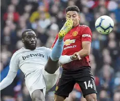  ?? — AP ?? That looks dangerous: West Ham’s Arthur Masuaku (left) nudges the ball away from Manchester United’s Jesse Lingard during the Premier League match at Old Trafford on Saturday.