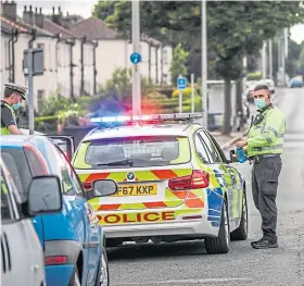  ?? ?? RAID: Police at the scene of the search. Picture by Mhairi Edwards.