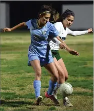  ?? RECORDER PHOTO BY CHIEKO HARA ?? Monache High School’s Alexa Baez, left, battles for a ball Tuesday, Dec. 4, during the second half of a game against El Diamante High School at Monache.