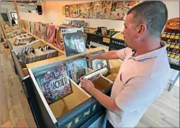  ?? Dan Watson/The Signal ?? Shaine Plummer flips through some of the vintage vinyl records on display for sale at Voodoo Vinyl in Newhall on Wednesday.