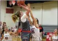  ?? AUSTIN HERTZOG - MEDIANEWS GROUP ?? Perkiomen Valley’s Quinn Boettinger, left, elevates and shoots over Owen J. Roberts’ Abby Smith during the first half Thursday.