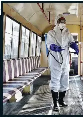  ??  ?? DEEP CLEANING: Spraying a tram in North Korea