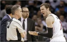  ?? CHUCK BURTON — THE ASSOCIATED PRESS ?? Miami Heat’s Goran Dragic, right, pleads to referee Mike Callahan, left, after being called for his third foul during the first half of Game 3 of an NBA basketball playoffs first-round series against the Charlotte Hornets in Charlotte, N.C., Saturday.
