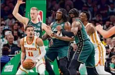  ?? Michael Dwyer/Associated Press ?? The Hawks’ Trae Young looks to pass in the first half during Game 1 vs. the Celtics on Saturday in Boston. Young had 16 points, but the Hawks were 5-for-29 from 3-point range.