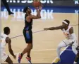  ?? KATHY WILLENS - THE ASSOCIATED PRESS ?? New York Knicks guard Immanuel Quickley (5) goes up for a shot with Orlando Magic forward Gary Clark (12) and Magic guard Jordan Bone (23) reacting during the first half of an NBA basketball game, Monday, Jan. 18, 2021, in New York.