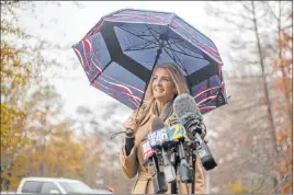  ?? Alyssa Pointer The Associated Press ?? Sen. Kelly Loeffler, R-GA., speaks with members of the news media Wednesday after participat­ing in early voting at Chastain Park Gymnasium in Atlanta.