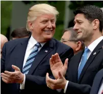  ?? AP ?? President Donald Trump talks to House Speaker Paul Ryan in the Rose Garden of the White House in Washington after the House pushed through the health care bill. —