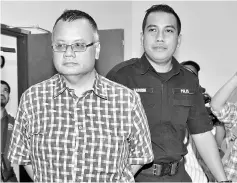  ??  ?? Zailan (left) pleaded not guilty after the charge was read to him. — Bernama photo