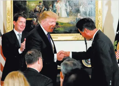  ?? Jonathan Ernst ?? Reuters U.S. President Donald Trump shakes hands Monday with a Japanese business leader at the U.S. ambassador’s residence in Tokyo.