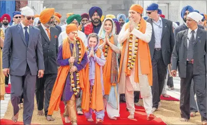  ?? PUBLIC RELATIONS OFFICE GOVT. OF PUNJAB VIA AP ?? Canadian Prime Minister Justin Trudeau, third right, walks with his family members during their visit to Golden Temple, in Amritsar, India, Wednesday. Trudeau is on a seven-day visit to India.