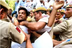  ?? — Reuters photo ?? Supporters of India’s main opposition Congress party scuffle with police during a protest demanding the resignatio­n of Akbar in New Delhi, India.