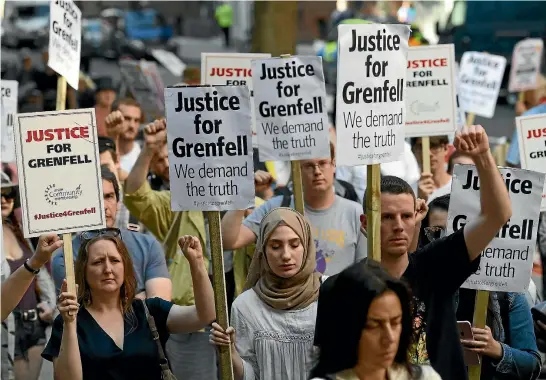  ?? GETTY IMAGES ?? Protesters attend a rally calling for justice for those affected by the Grenfell Tower fire outside the Department for Communitie­s and Local Government in London yesterday.